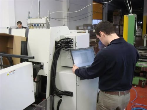 2009 photo of Mathieu standing near virtuo with a laptop