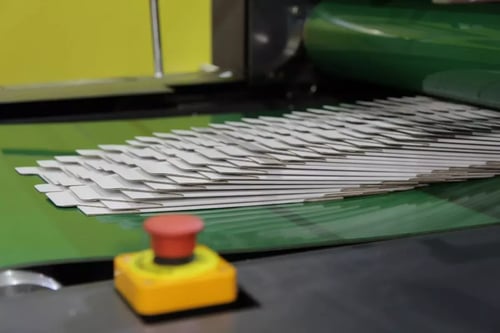 21-073 An overstack shingle exiting the folder-gluer’s delivery belt