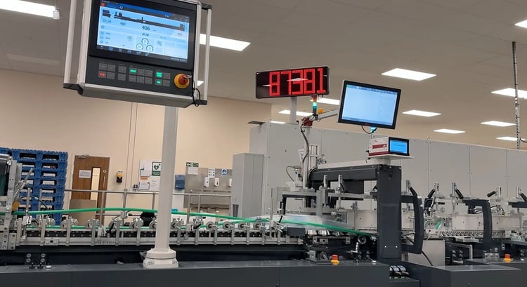 K&amp;B Folder-gluer screen shows a speed of 87,381 cartons per hour